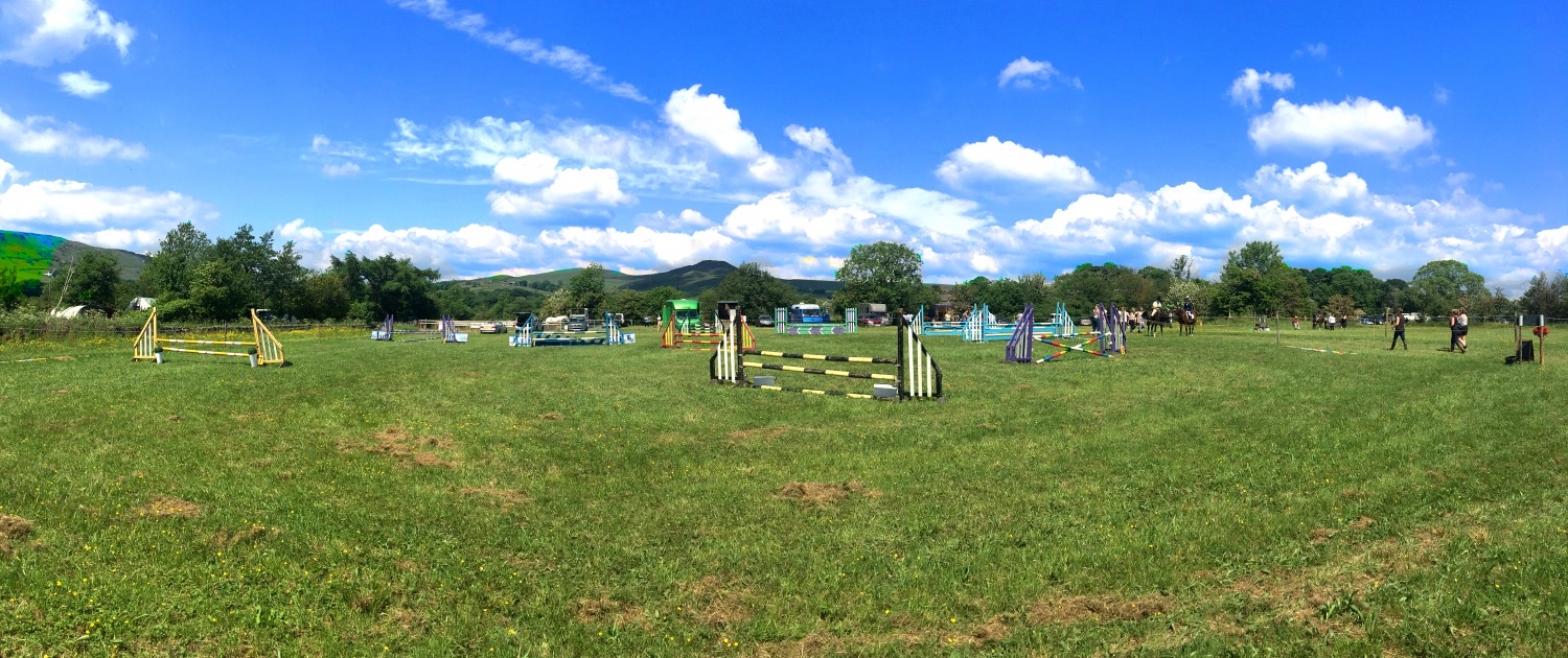 CDRC's Charley Lane showground — jumps set up across a green field with the Peak District hills behind